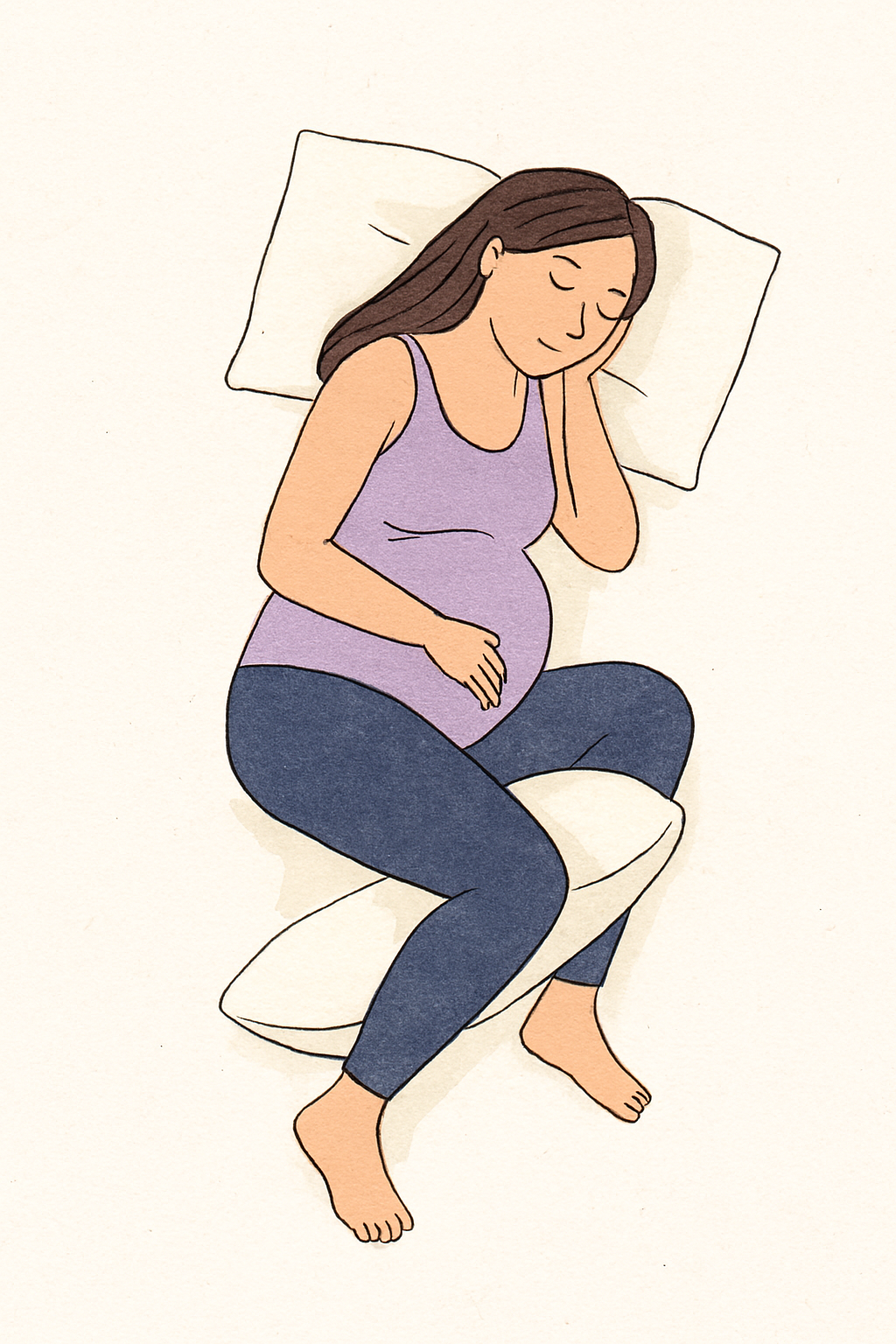 Pregnant woman sleeping on her side with pillows between her legs and under her belly